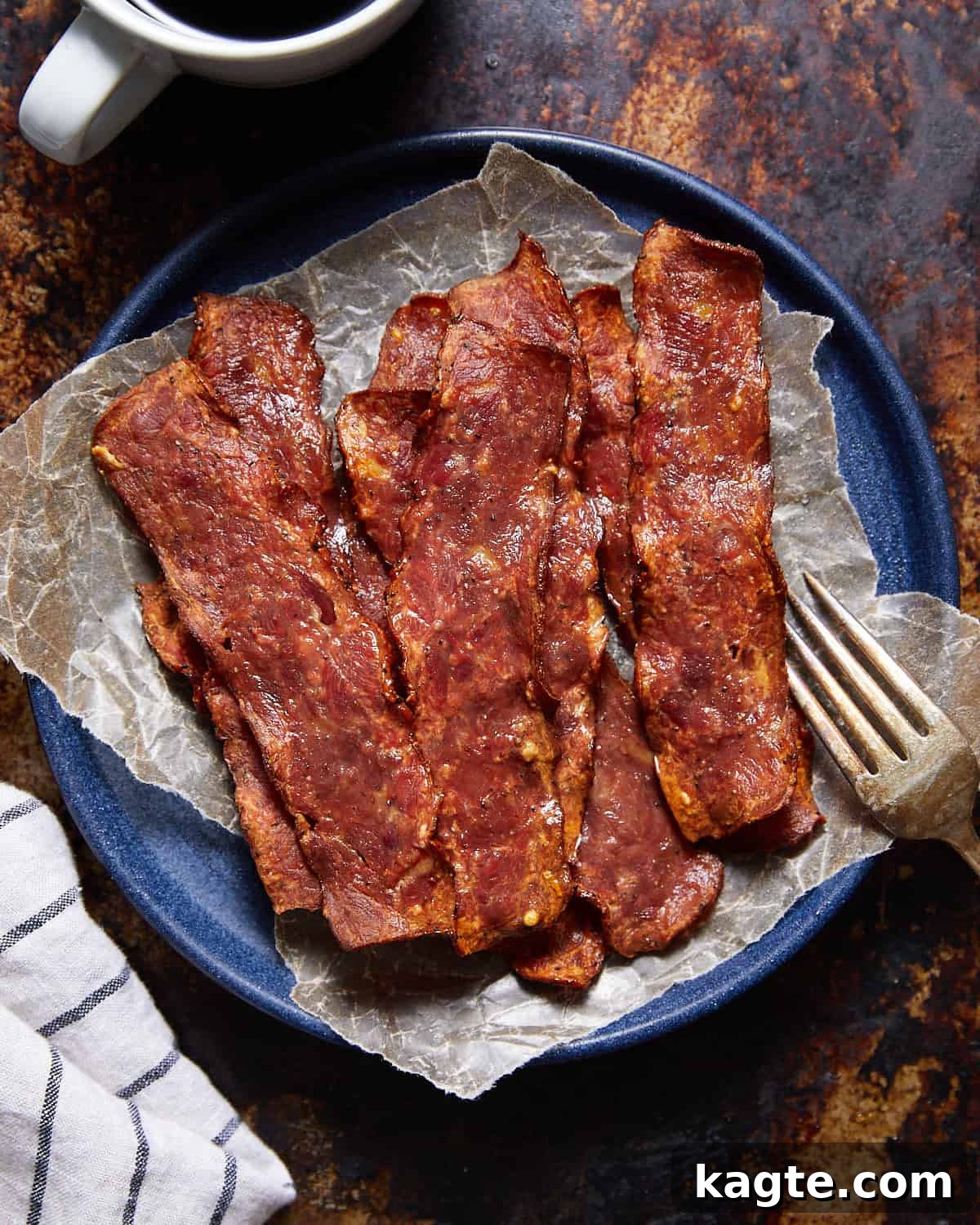 Bake Your Turkey Bacon to Crispy Perfection 2 Oven baked turkey bacon on a blue plate.