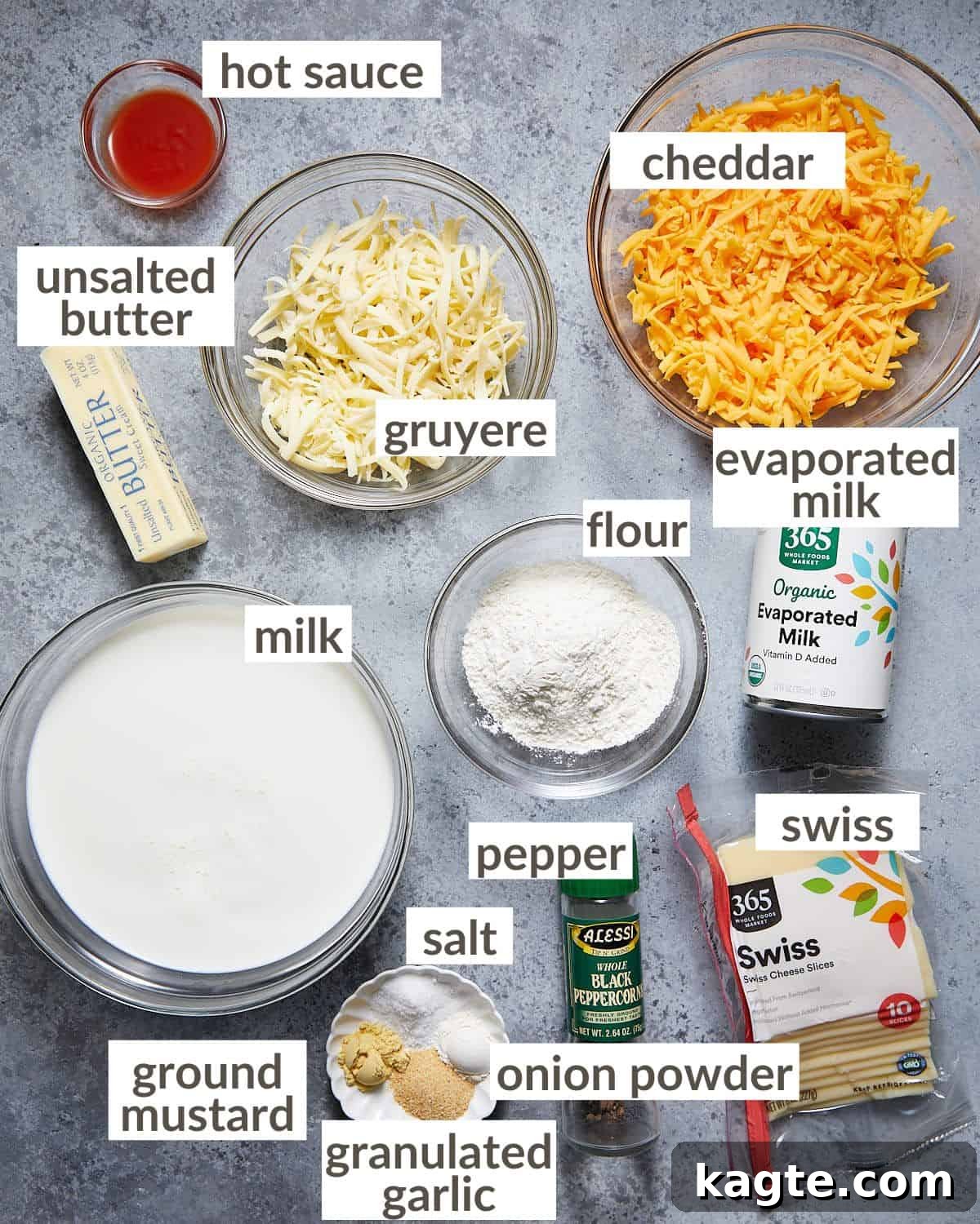 Rich and Creamy Homemade Mac and Cheese Sauce 3 Ingredients laid out on a counter for making mac and cheese sauce, including butter, flour, milk, cheese, and spices.