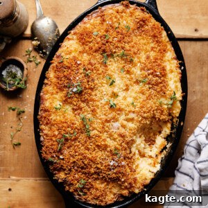 A close-up of a bubbling cheesy hashbrown casserole fresh from the oven, ready to be served.