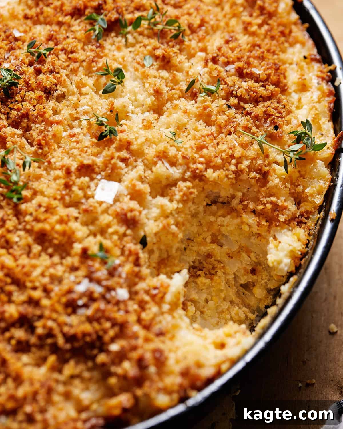 Simple Cheesy Hashbrown Casserole From Scratch 6 A close-up view of the cheesy hashbrown casserole, showing the crispy topping and melted cheese interior.