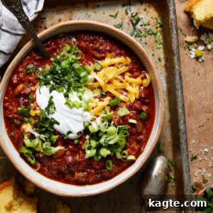 A top-down shot of Dutch oven chili in a pot, ready to be served.