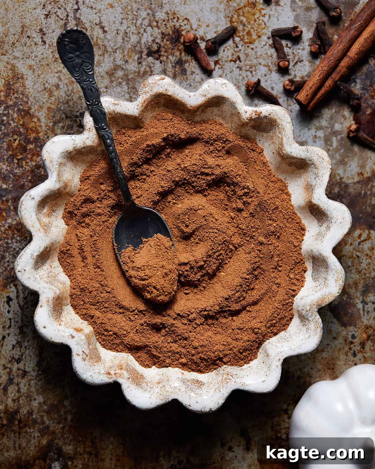 Pumpkin Spice Alternatives 2 Pumpkin pie spice substitute in a small white dish, showcasing its rich, warm color.