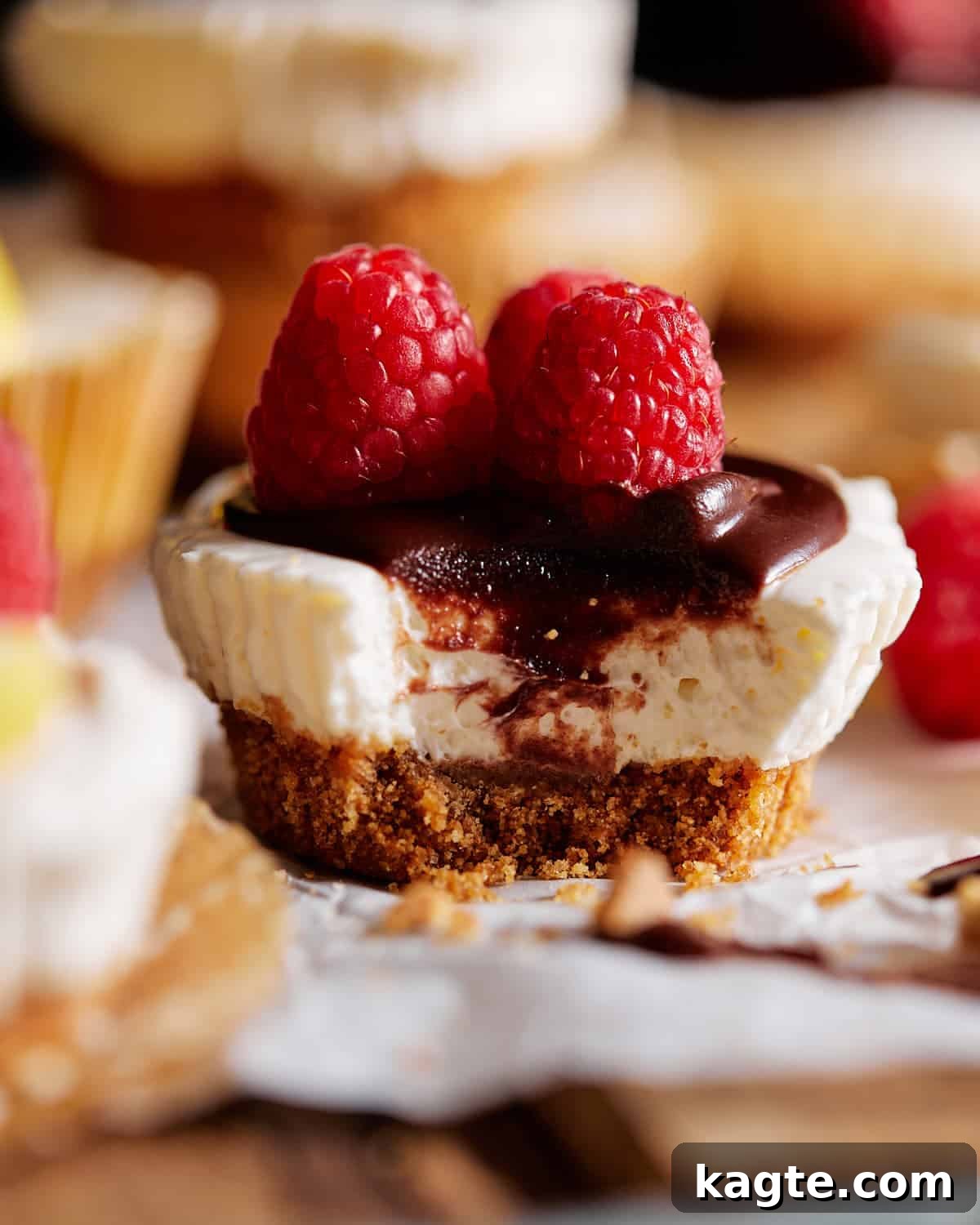 Simple No-Bake Mini Cheesecakes 2 Mini no bake cheesecake with chocolate and raspberries on top. A delicious, individual serving dessert.