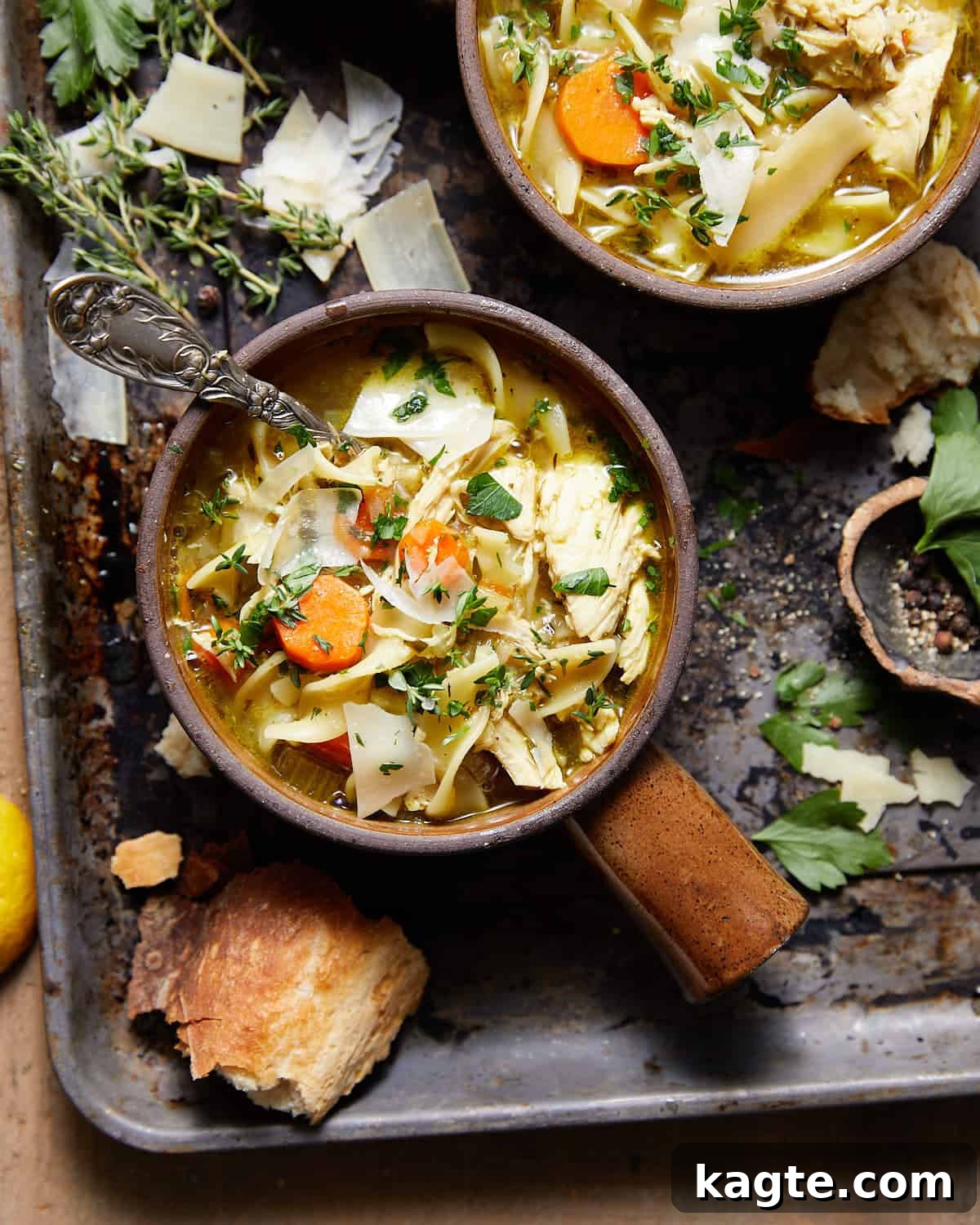 Dutch Oven Chicken Noodle Delight 2 A steaming bowl of homemade Dutch oven chicken noodle soup, garnished with fresh herbs and served with crusty bread.