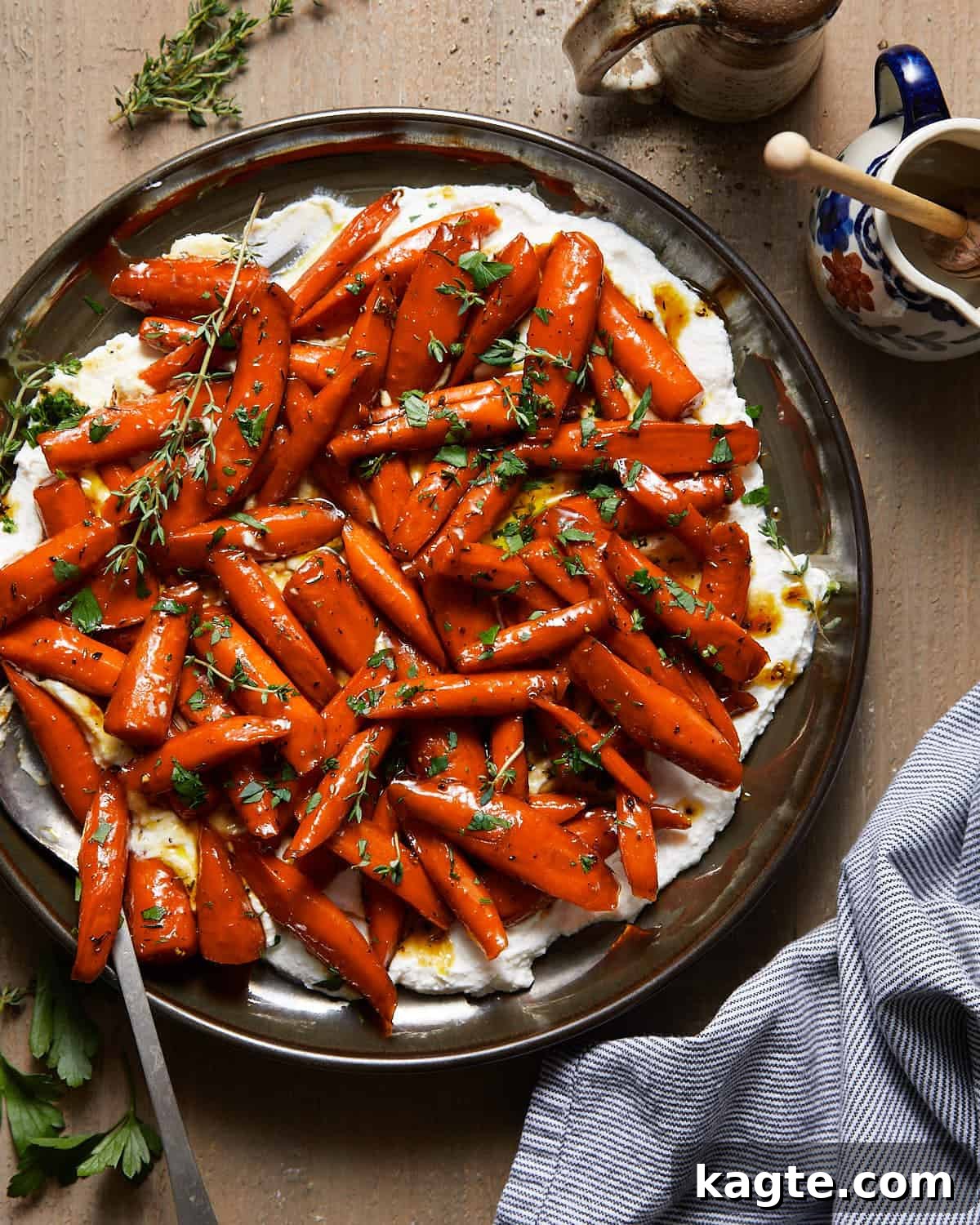 Sticky Sweet Honey Brown Sugar Carrots 2 Brown sugar honey glazed carrots on a bed of ricotta cheese, garnished with fresh herbs.