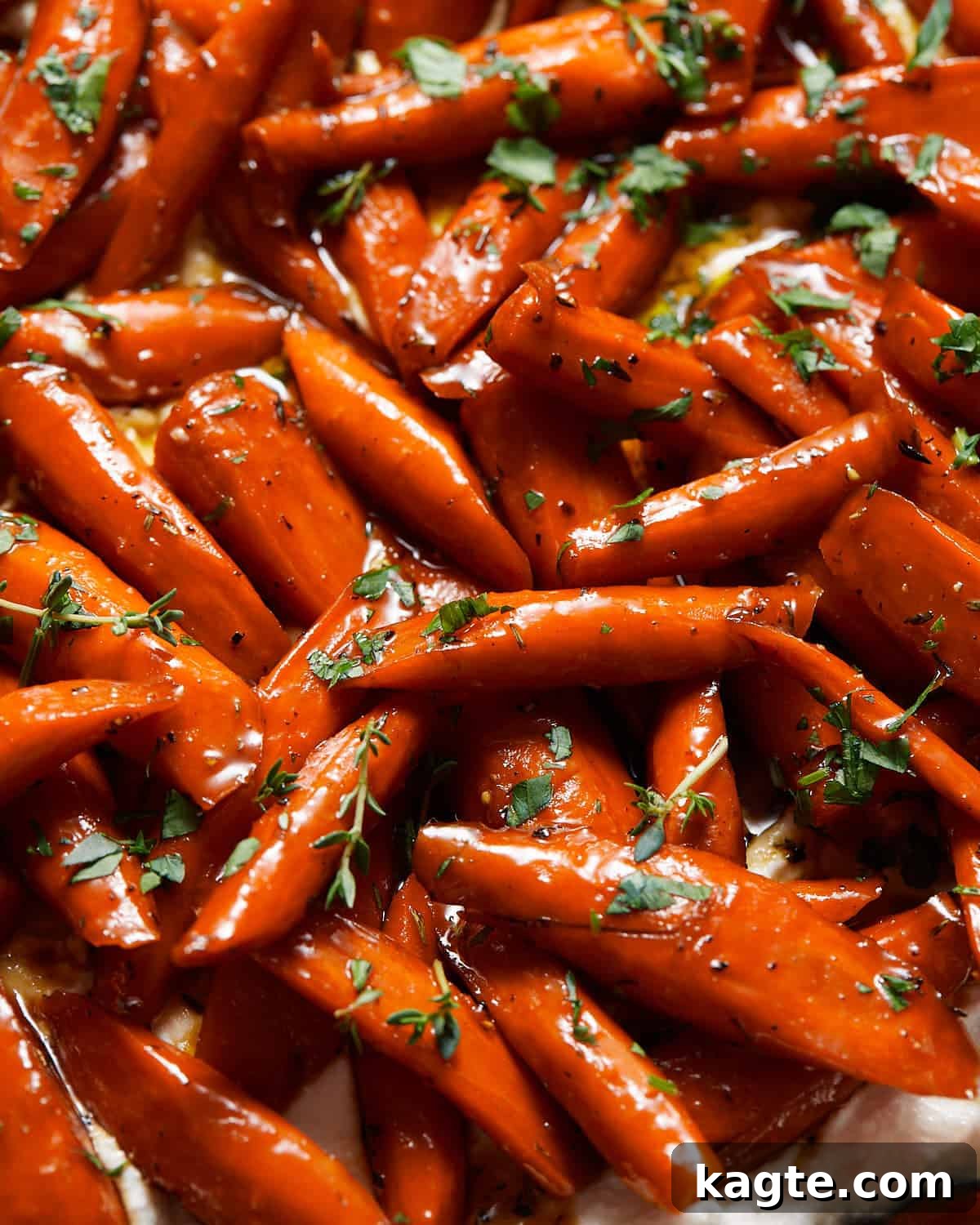 Sticky Sweet Honey Brown Sugar Carrots 6 Close-up of honey brown sugar glazed carrots, garnished with fresh herbs.
