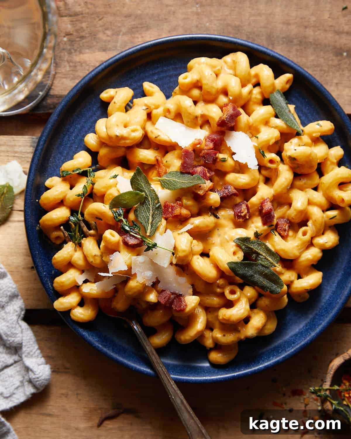 Golden Pumpkin Pasta Sauce 2 Pumpkin pasta sauce tossed with cavatappi on a blue plate.