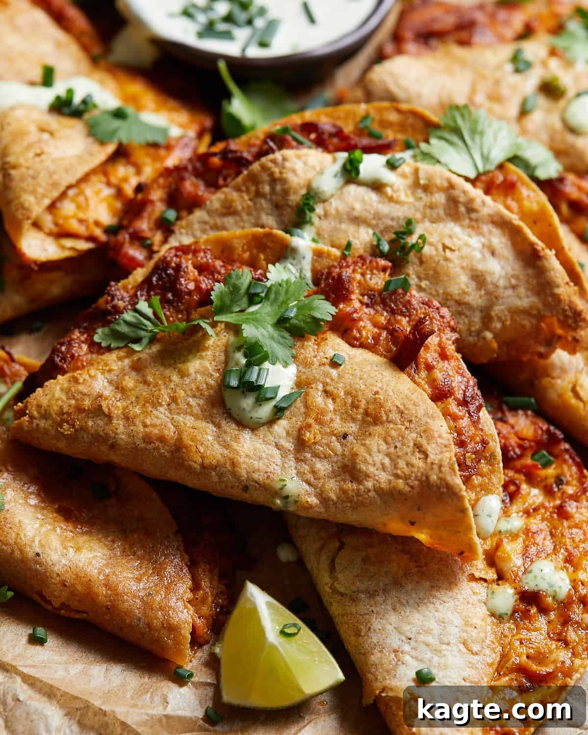 Air fryer buffalo chicken tacos with ranch drizzled on top.
