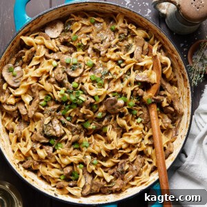 Healthy Beef Stroganoff in a bowl with egg noodles and fresh herbs.