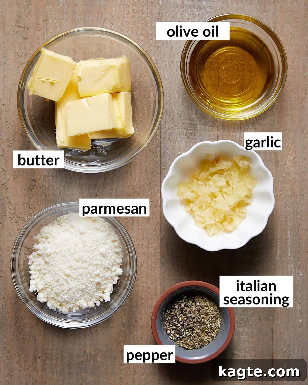 Close-up image of fresh ingredients laid out for making the garlic bread spread, including butter, garlic, Parmesan, and herbs.