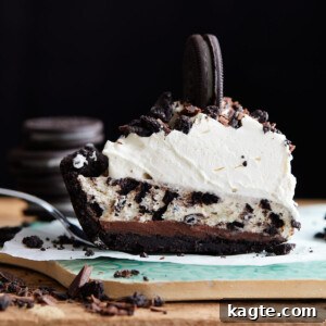 Effortless Oreo Cheesecake Bliss 7 Close-up image of a full No Bake Oreo Cheesecake Pie, topped with whipped cream and crushed Oreos.