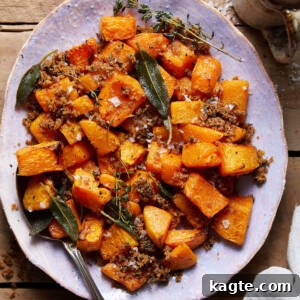 A close-up of a serving of air-fried butternut squash with crispy brown butter herb panko topping on a plate.