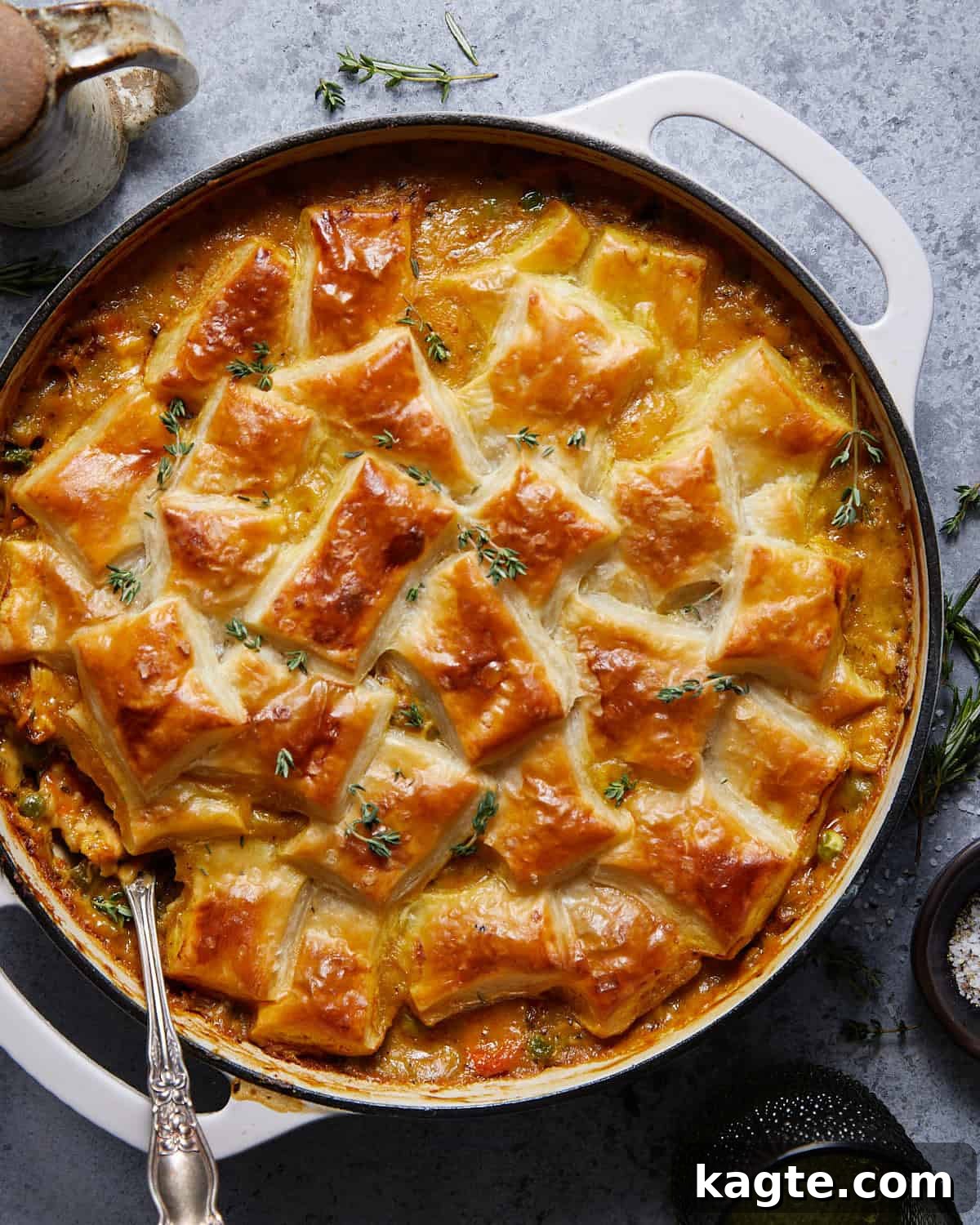 Golden Flaky Chicken Pot Pie 2 Overhead image of chicken pot pie with puff pastry. Golden, flaky crust covers a rich, creamy filling with visible vegetables.
