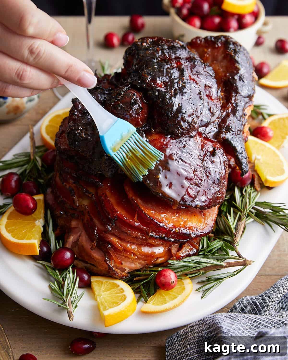 Your Go-To Recipe for Juicy Spiral Ham 6 A spiral ham being generously brushed with a sweet honey glaze, showing the beautiful caramelization process.