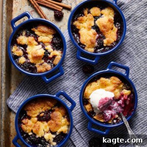 Perfectly baked Air Fryer Blackberry Cobbler with a scoop of vanilla ice cream, ready to be enjoyed.
