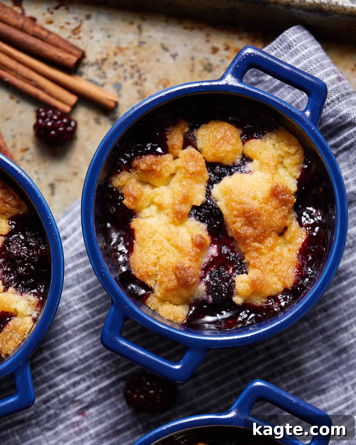 Close-up image of a single Air Fryer Blackberry Cobbler, showing its bubbly fruit filling and perfectly golden-brown biscuit topping, ready to be enjoyed.
