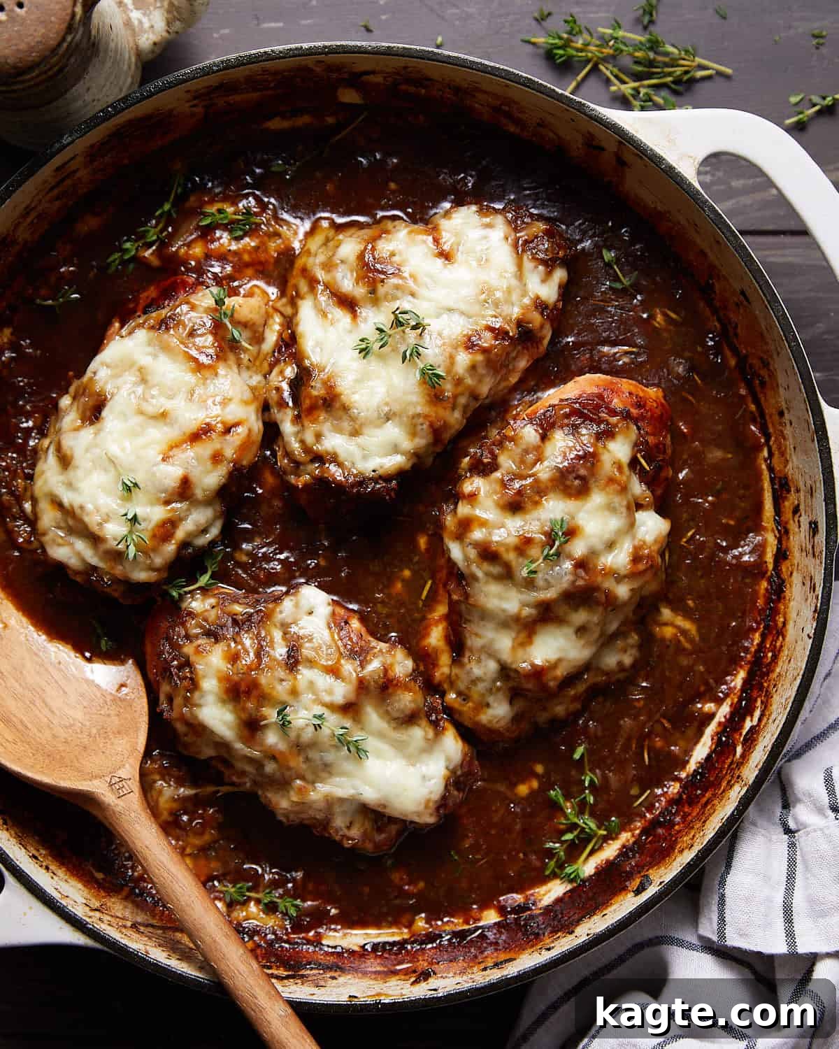 Caramelized Onion and Gruyère Chicken Bake 2 Overhead image of French onion chicken bake in a Dutch oven, garnished with fresh herbs.