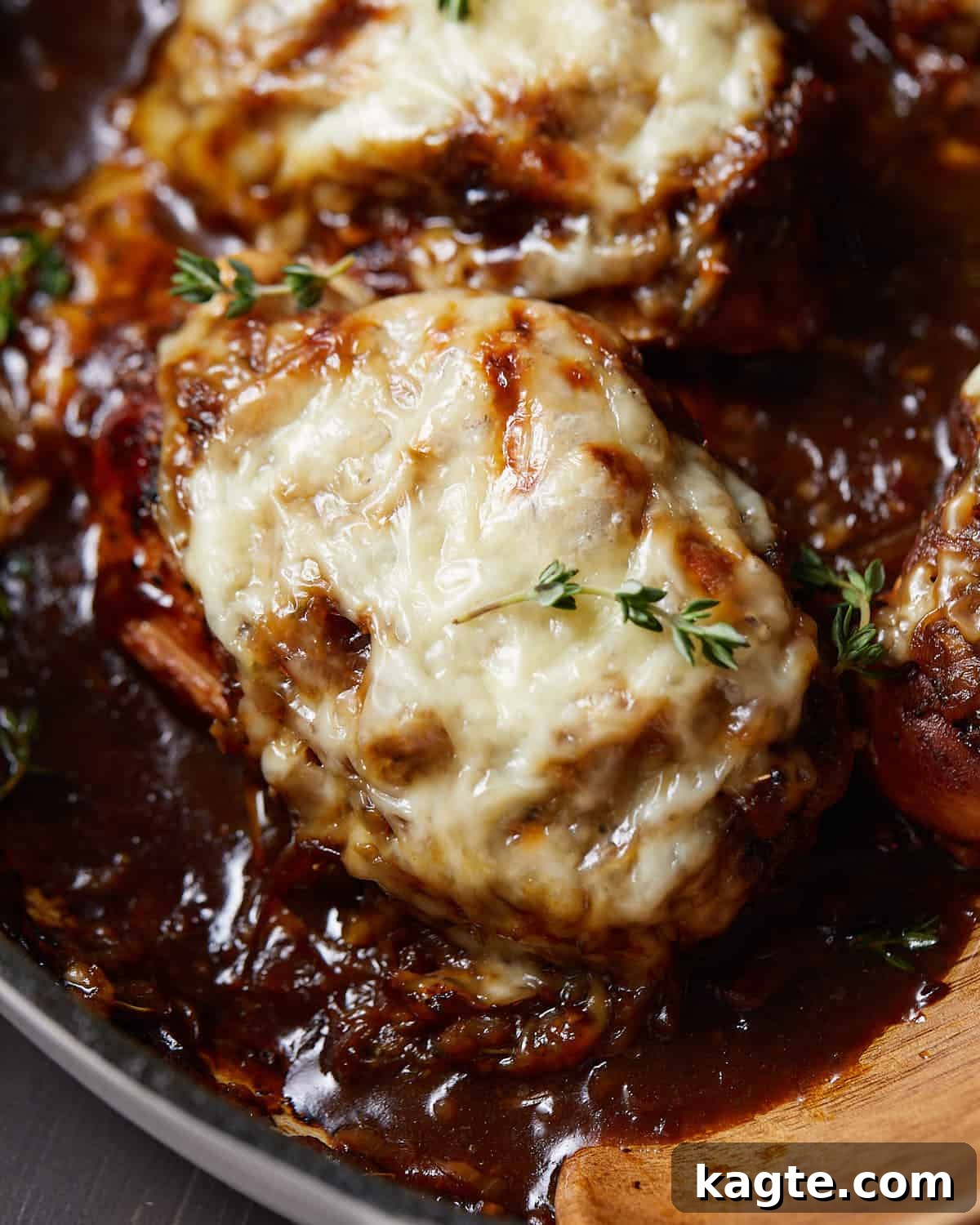 Caramelized Onion and Gruyère Chicken Bake 6 Overhead and close-up view of French onion chicken bake with golden melted cheese, ready to serve.