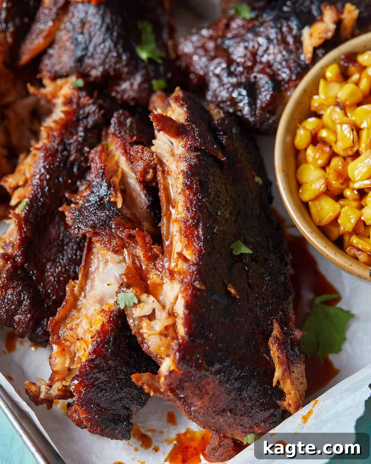 Fall-Off-The-Bone Oven Ribs 6 Up close image of a baby back rib with garnish.