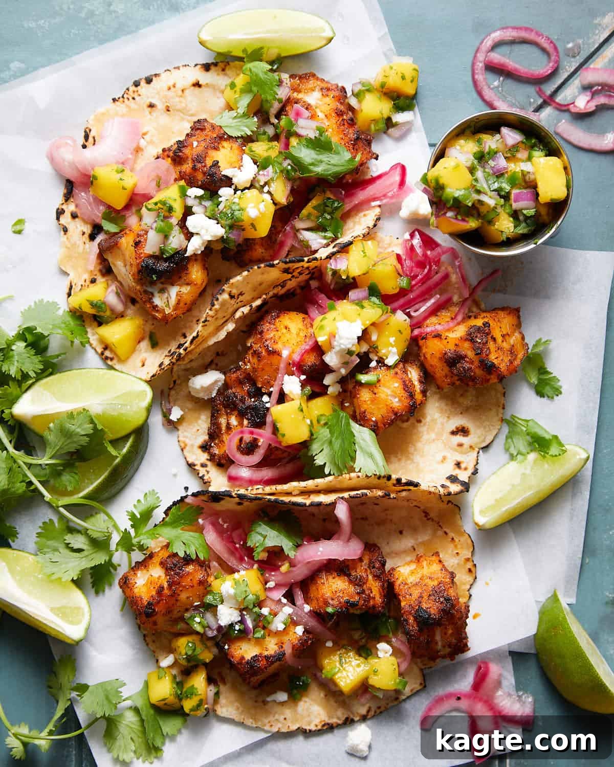 Mango Tango Fish Tacos 2 An overhead image of fish tacos with mango salsa and garnish.