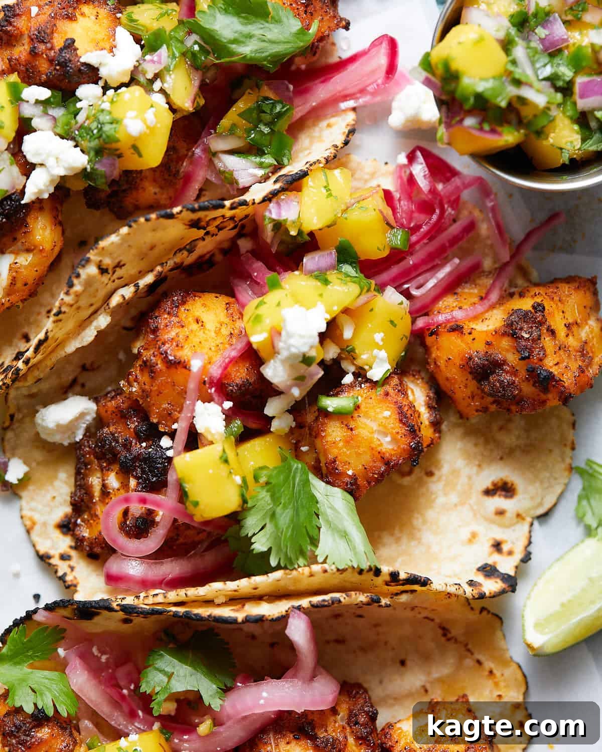 Mango Tango Fish Tacos 5 An up close image of a fish taco with mango salsa.
