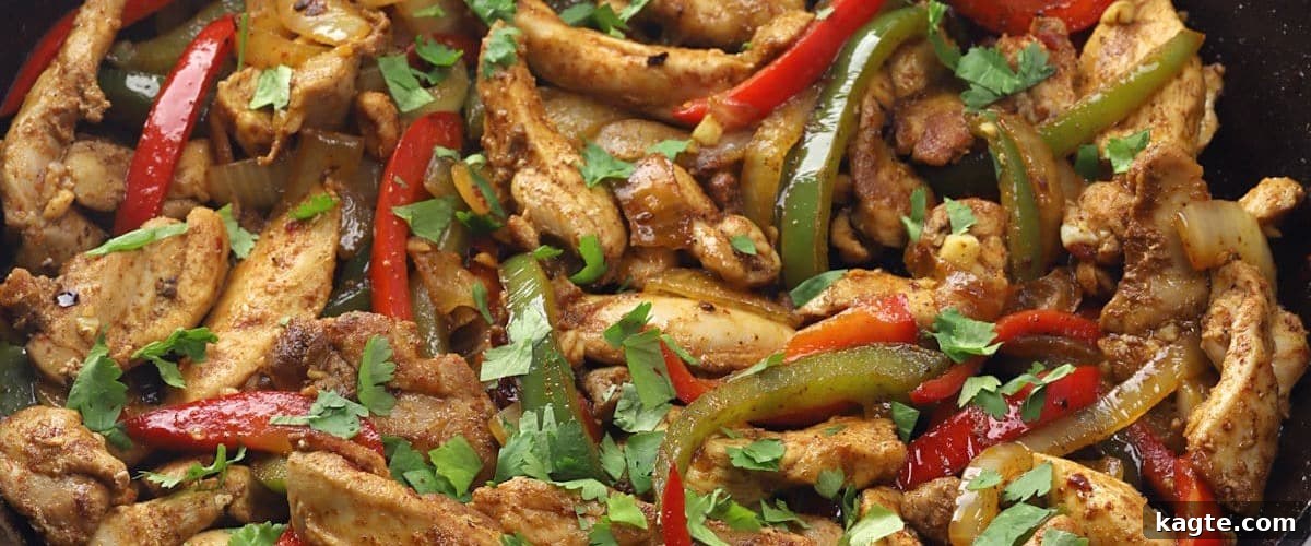 25 Hassle-Free Boneless Chicken Thigh Ideas 11 Sizzling skillet chicken fajitas, bursting with bell peppers and other vibrant vegetables, ready to serve.