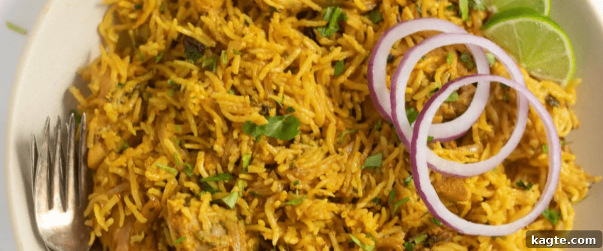 25 Hassle-Free Boneless Chicken Thigh Ideas 17 Aromatic Instant Pot chicken biryani, served in a white bowl with fresh garnish.