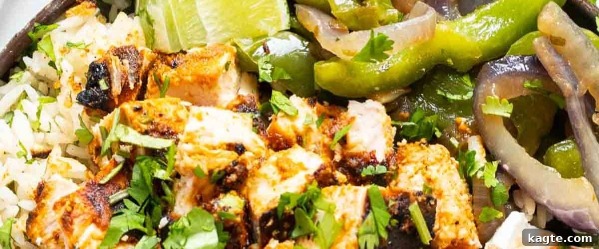 25 Hassle-Free Boneless Chicken Thigh Ideas 26 Pollo asado served with fluffy white rice and colorful mixed vegetables.