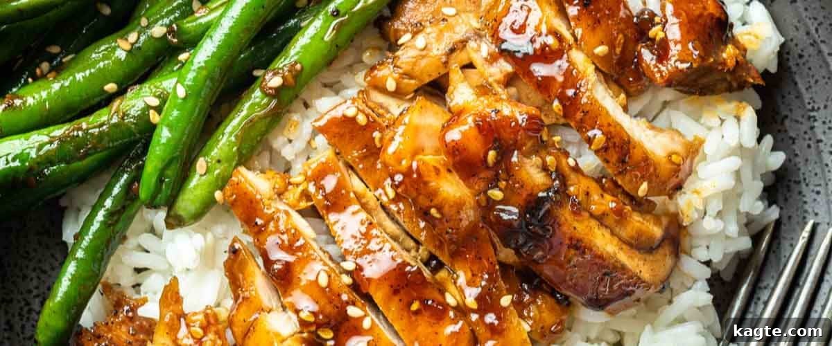 25 Hassle-Free Boneless Chicken Thigh Ideas 28 Savory chicken teriyaki served over white rice in a modern grey bowl.