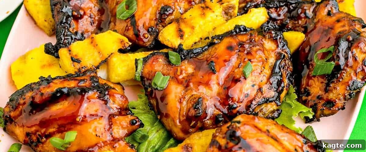 25 Hassle-Free Boneless Chicken Thigh Ideas 31 Tropical Huli Huli chicken, beautifully plated with pineapple and fresh garnish.