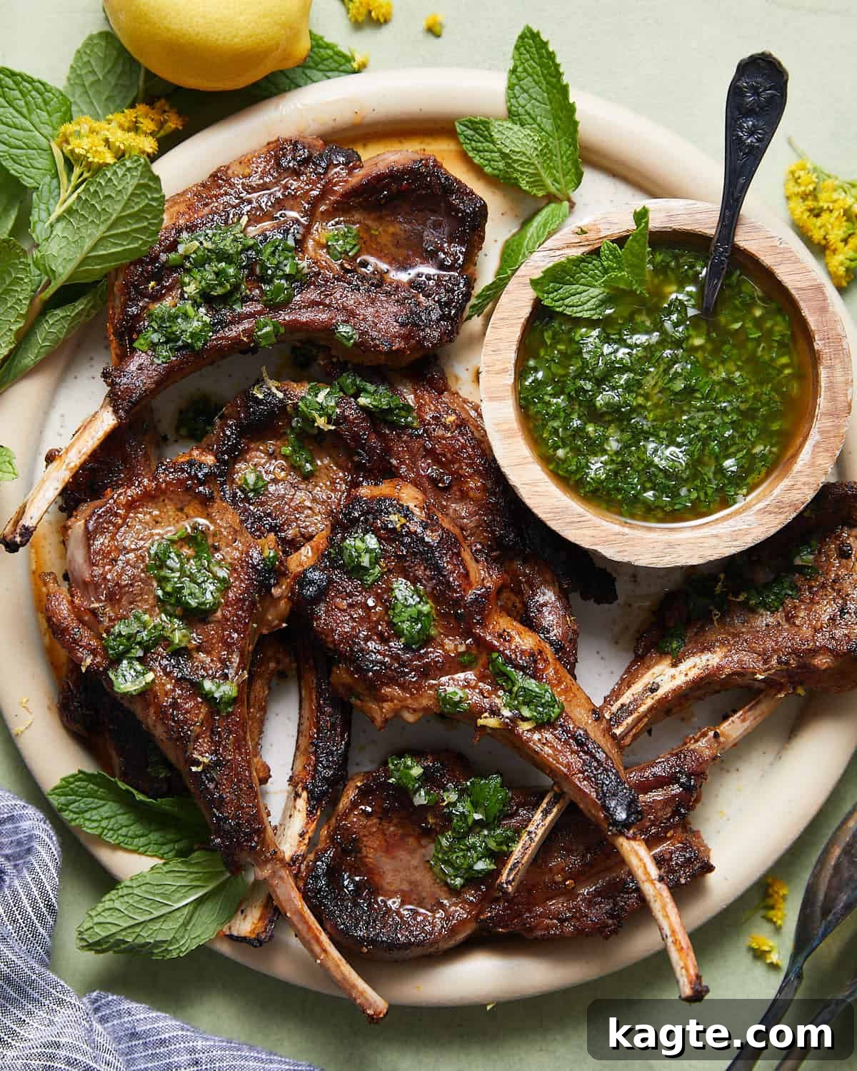 Sizzling Cast Iron Lamb Chops 2 Overhead photo of cast iron skillet lamb chops on serving platter with garnish.