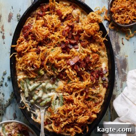 A vibrant green bean casserole with crispy bacon pieces and creamy sauce, presented in a baking dish.