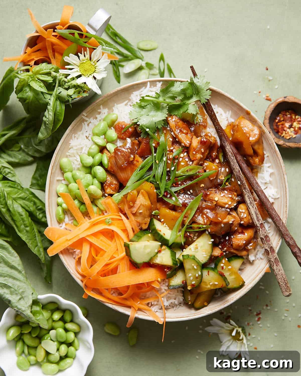Overhead image of teriyaki chicken bowl with garnish, showcasing its vibrant colors and inviting texture.