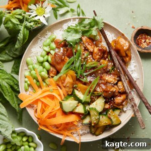 A finished teriyaki chicken rice bowl with fresh garnishes.