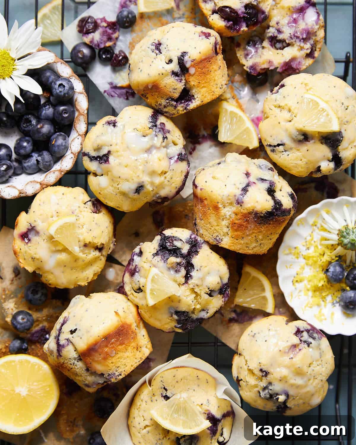 Overhead image of freshly baked blueberry lemon poppy seed muffins, glistening with lemon glaze.