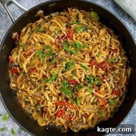 Overhead image of vegetable lo mein with garnish.
