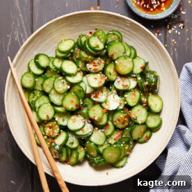 Overhead image of spicy cucumber salad in white dish.