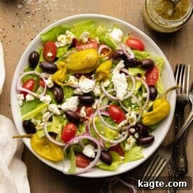 Overhead image of a refreshing Panera Greek Salad copycat with crisp greens, feta, olives, and a tangy dressing.