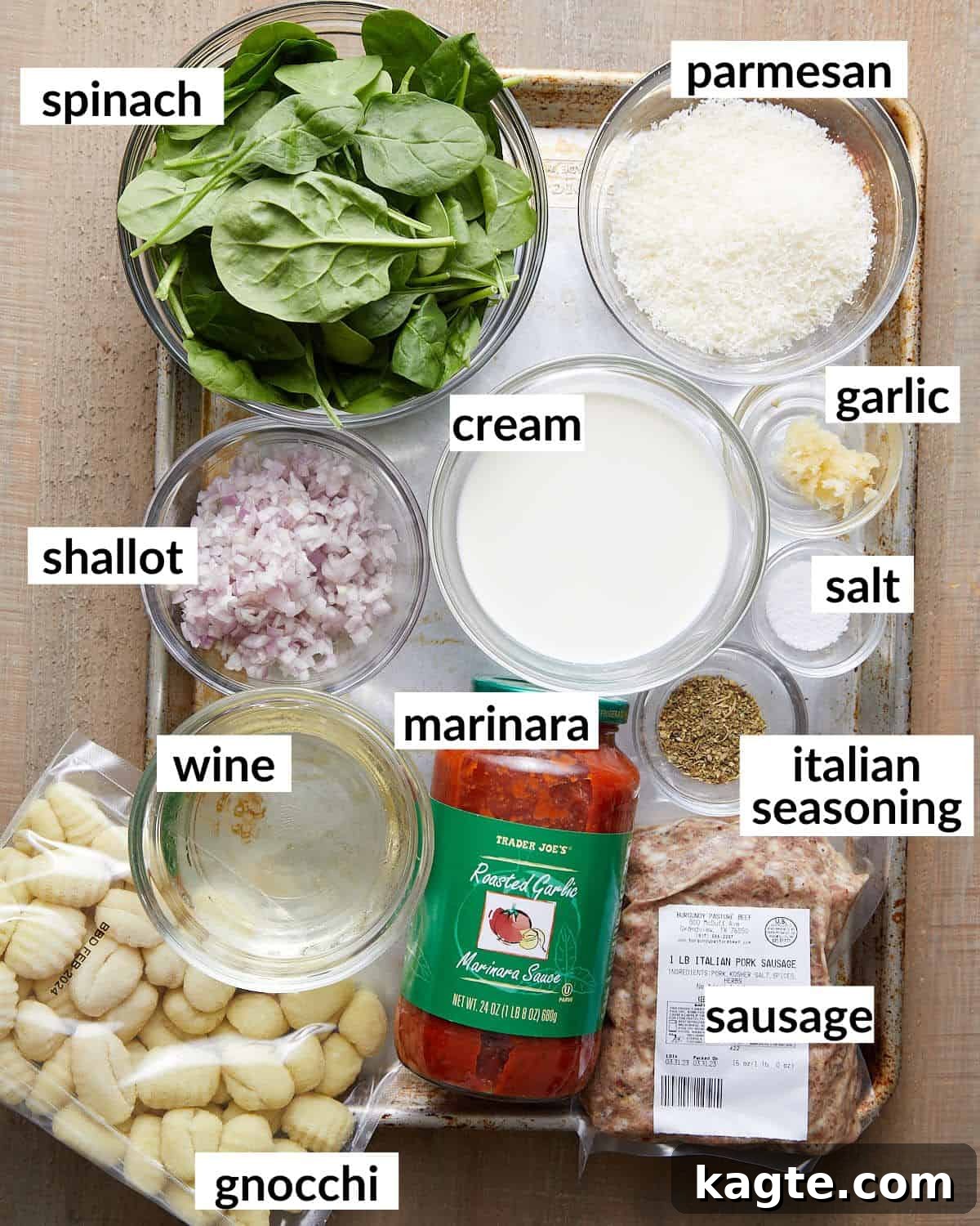 Creamy Sausage Gnocchi with Tomato and Spinach 3 A flat lay photograph showcasing all the fresh and pantry ingredients needed for creamy sausage gnocchi, including ground Italian sausage, shelf-stable gnocchi, marinara sauce, heavy cream, fresh spinach, garlic, shallots, and seasonings.