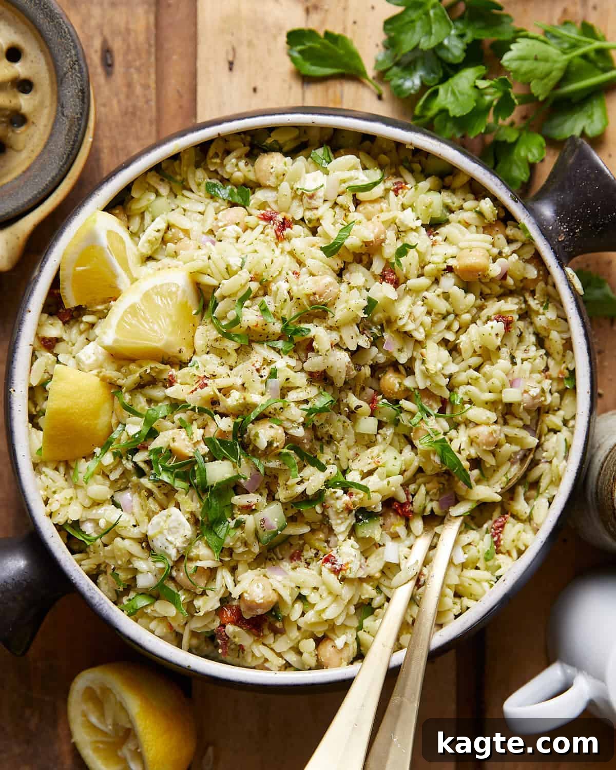 Effortless Pesto Orzo Salad 2 An overhead image of pesto orzo salad with garnish, showcasing vibrant colors and fresh ingredients.