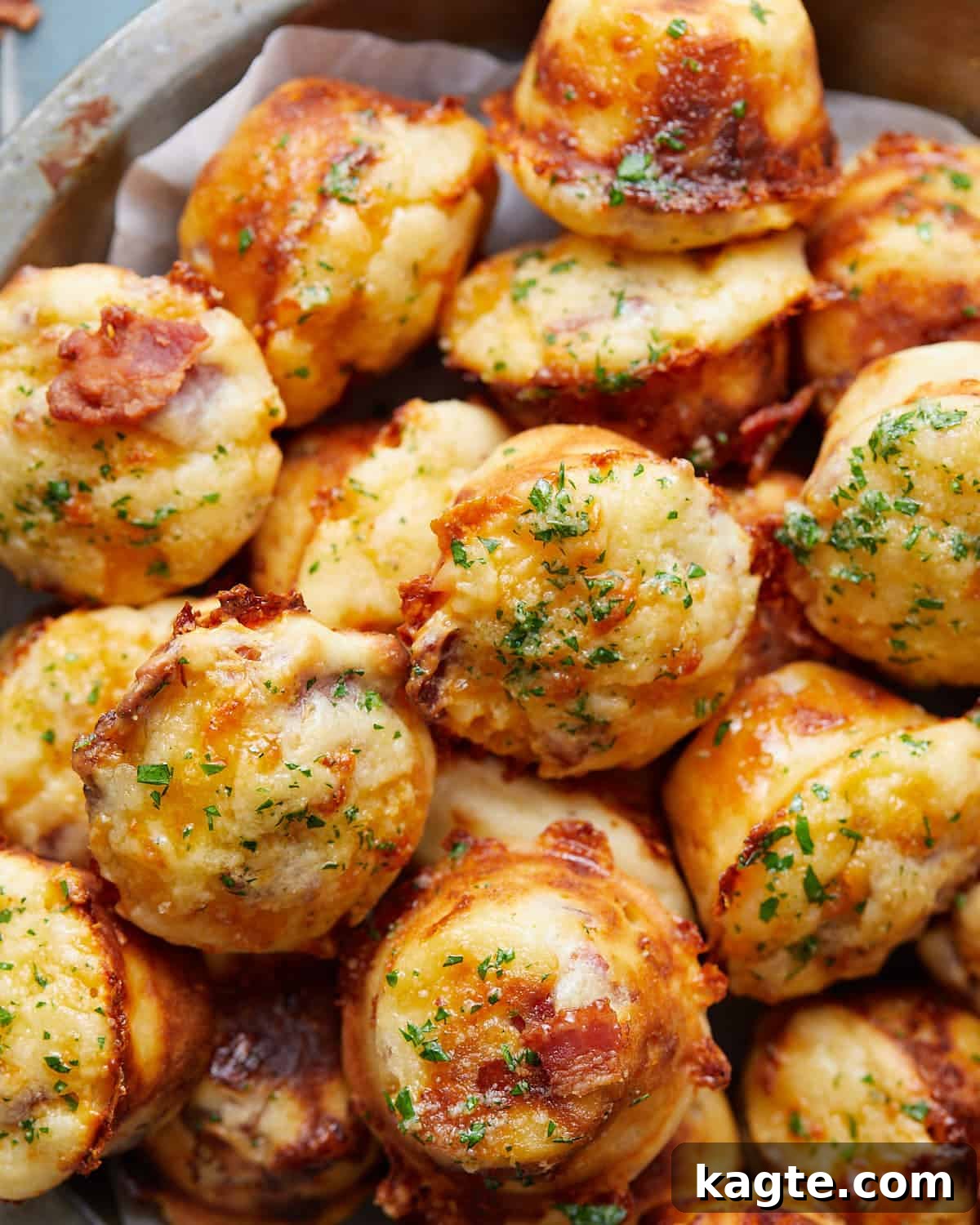 Golden Bacon Cheddar Muffins 2 Overhead image of freshly baked savory bacon and cheddar cheese muffins, garnished with fresh chives, ready to be served.