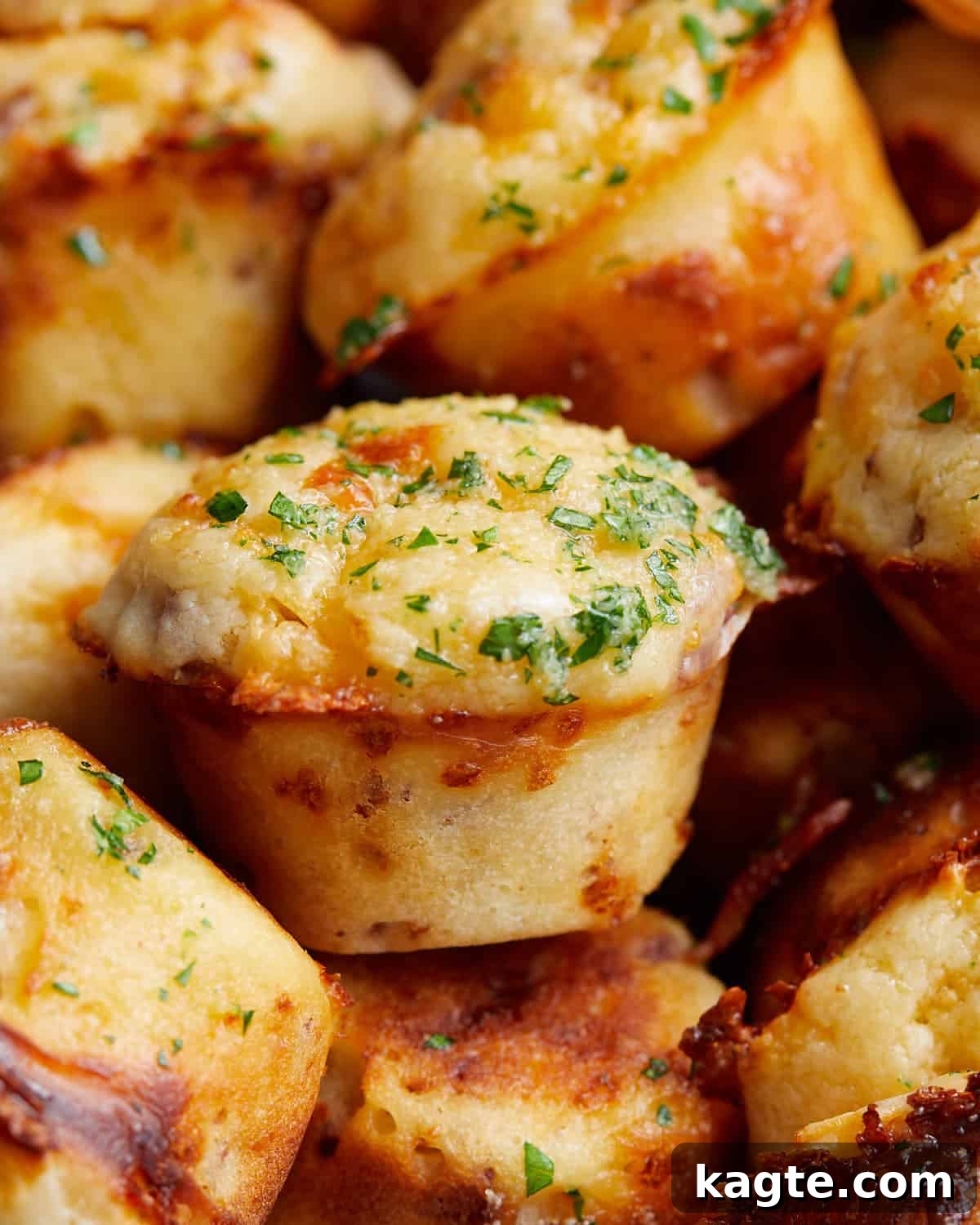 Golden Bacon Cheddar Muffins 5 Close-up detailed image of a single savory bacon and cheddar cheese muffin, showing the crispy bacon bits and melted cheese on top.