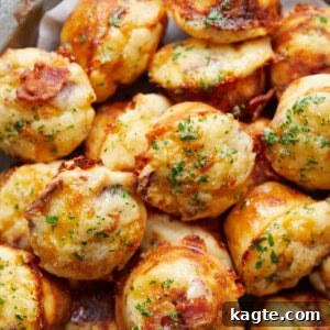 A close-up of a stack of savory bacon and cheddar cheese muffins on a small plate.
