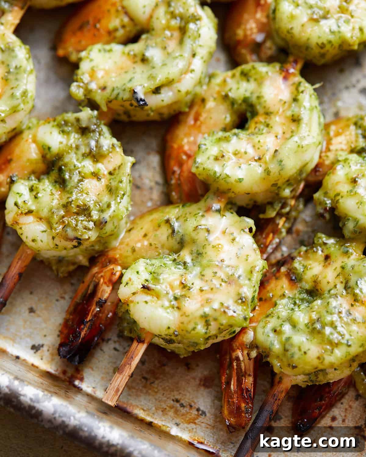 Juicy Oven Baked Shrimp Skewers 5 Up close image of perfectly cooked oven baked shrimp skewers, garnished with fresh cilantro.