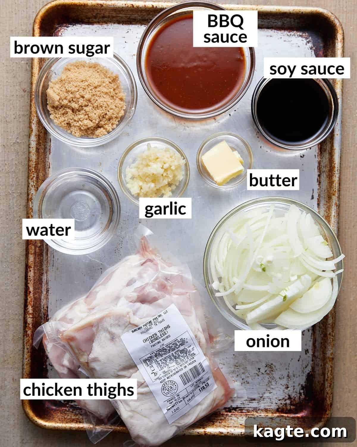 An overhead image of ingredients needed for Dutch oven BBQ chicken, including chicken thighs, barbecue sauce, brown sugar, and fresh aromatics.