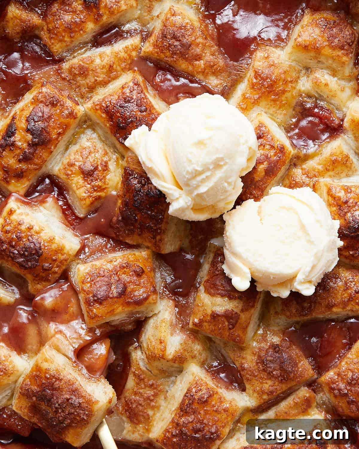Golden Flaky Peach Cobbler 6 A close-up, inviting image of a warm peach cobbler with puff pastry, showing the flaky golden crust and bubbling peach filling, served with melting vanilla ice cream.