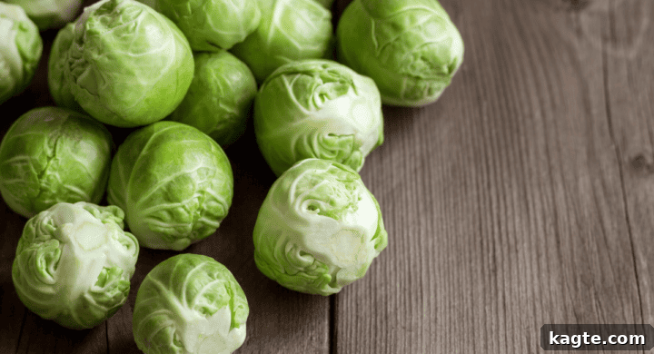 A cluster of fresh green Brussels sprouts, still on the stalk.