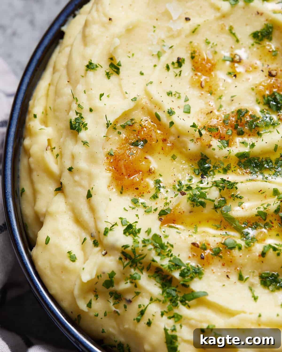 Velvety Yukon Gold Mash 5 Up close image of a spoonful of creamy Yukon Gold mashed potatoes, showing their smooth texture.