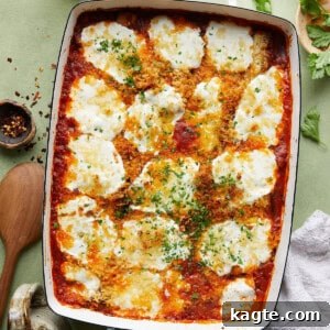 Italian Baked Zucchini ready to serve, showing gooey cheese and rich sauce.