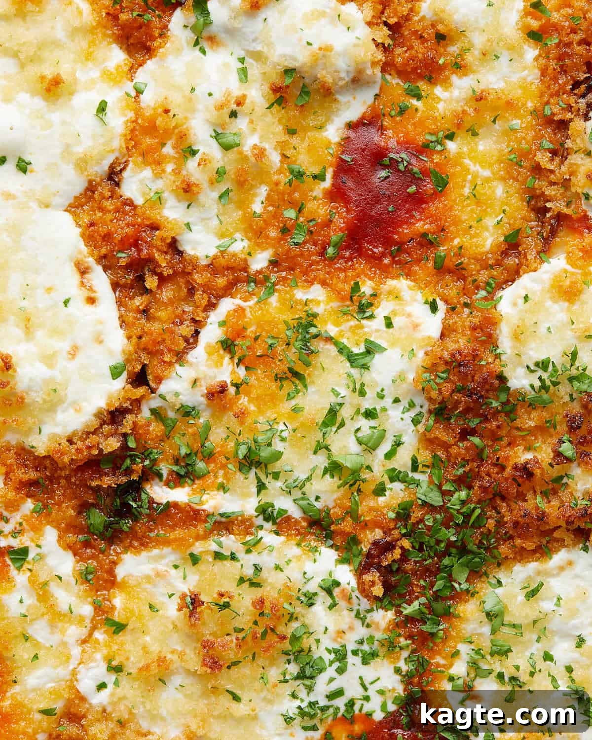 Close-up image of a serving of Italian baked zucchini, showing the melted cheese, savory sauce, and tender zucchini slices.